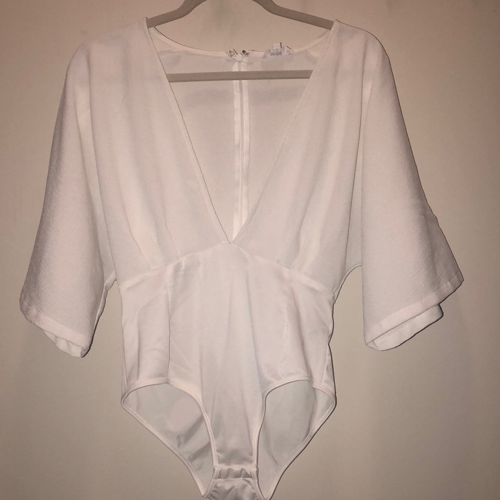 White body suit with deep v-neck. Never Worn!